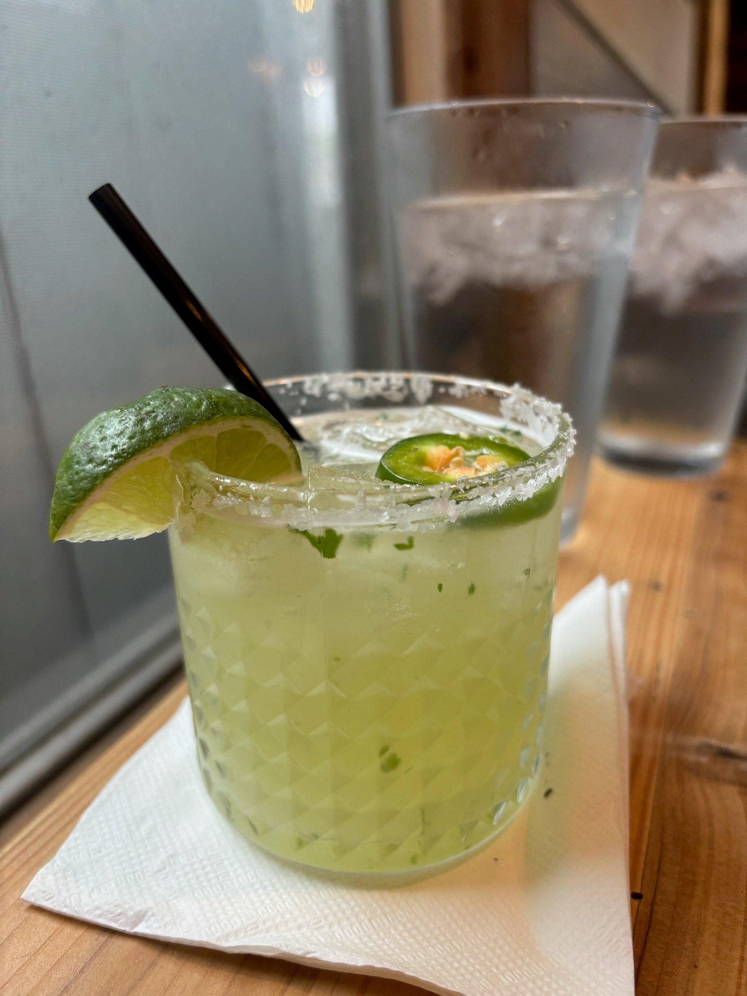 A margarita with a lime and straw