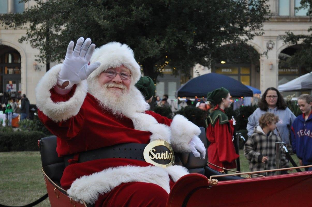 Santa Clause waving at people looking