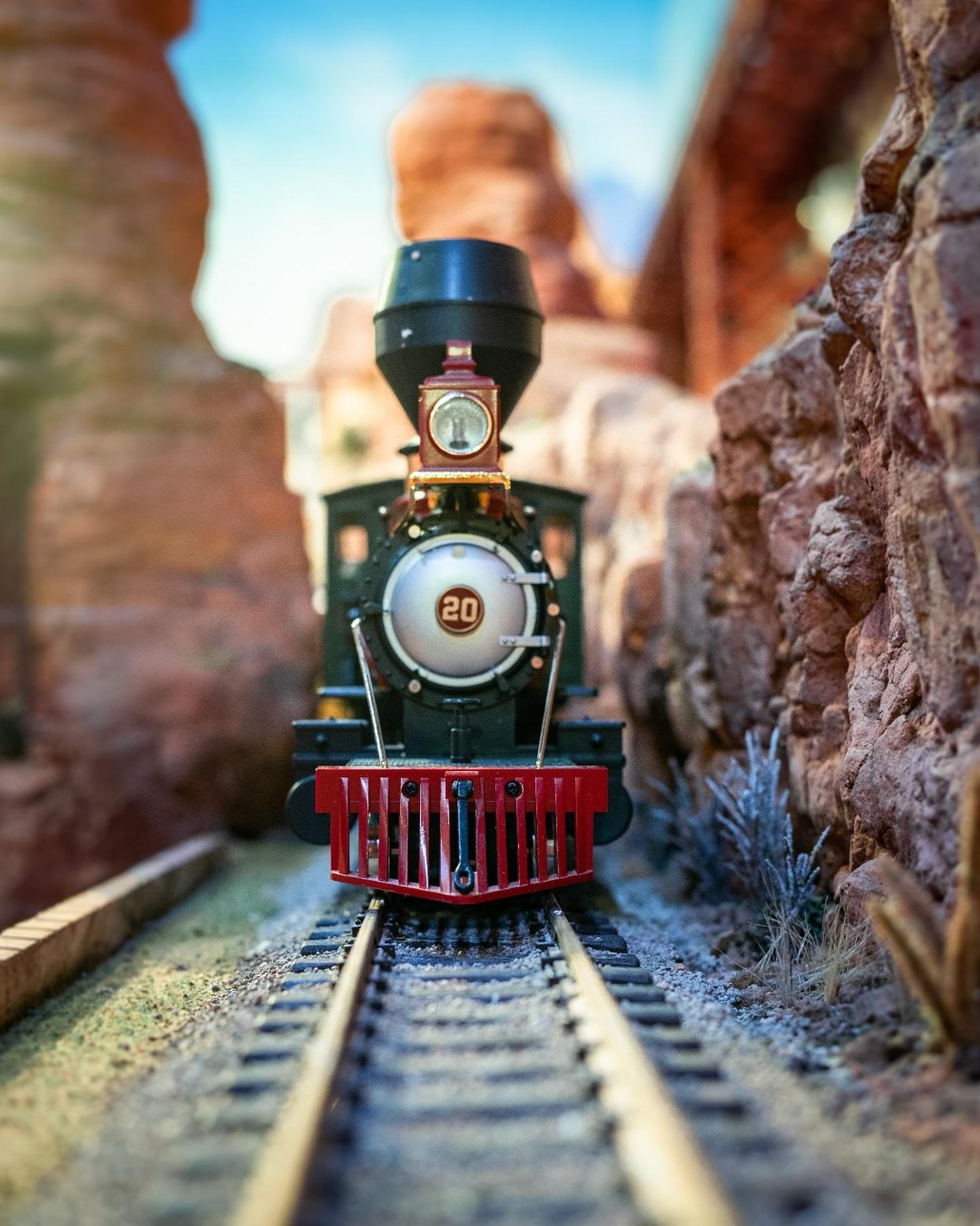 A model train bearing head-on down a track