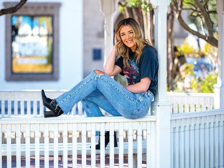 Grace Tyler sitting on the railing of a gazebo